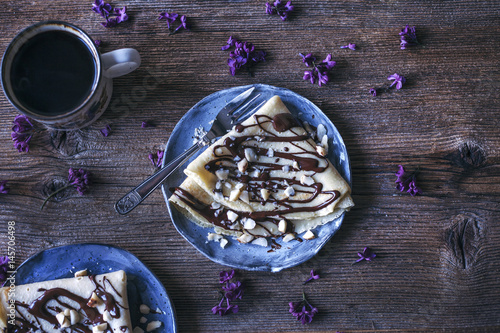 Crepes with dark chocolate drizzle and Brazil nuts