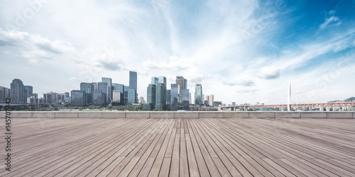 empty wooden floor with cityscape of modern city