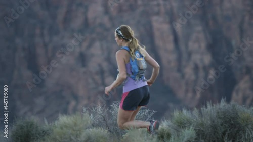 slow motion of girl trail running in desert in Southern Utah