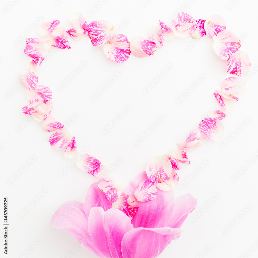 Heart symbol of roses petals and tulip flower on white background. Flat lay, Top view 