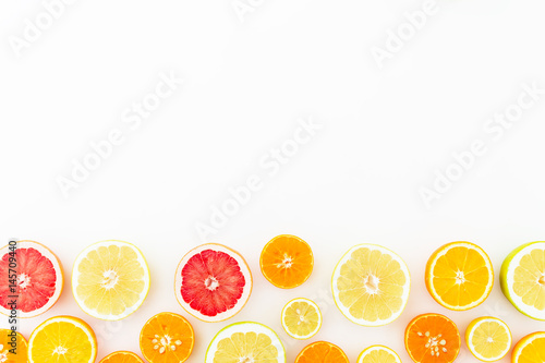 Tropical summer mix with fresh citrus fruits - lemon  orange  mandarin  grapefruit and sweetie on white background. Flat lay  top view.