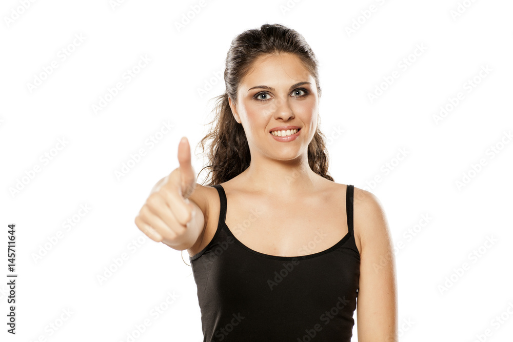 young beautiful brunette showing thumbs up young beautiful brunette showing thumbs up