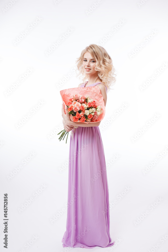 Portrait of beautiful curly blondy woman with perfect make-up. Holding bouquet. Long evening purple dress
