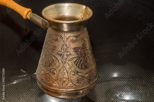 Фотография Brassy cezve on stove