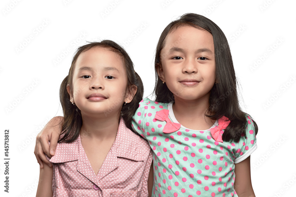 Happy two asian little girl hugging and having fun Happy two asian little girl hugging and having fun