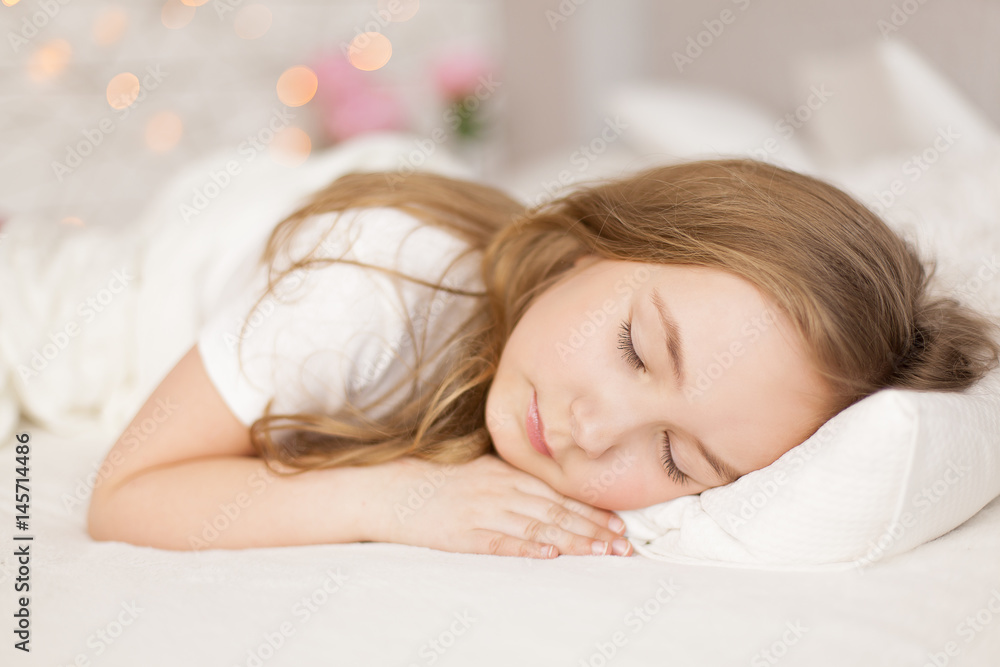Little girl sleep in her bed. Background with bokeh Little girl sleep in her bed. Background with bokeh