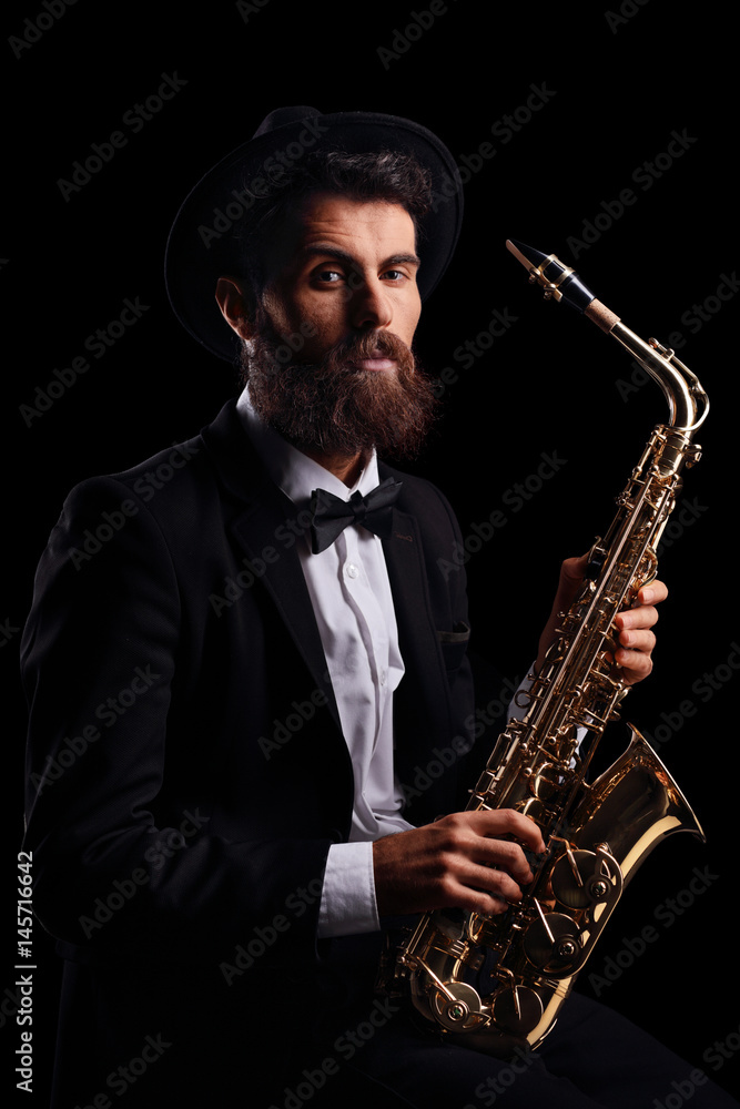 Naklejka premium Bearded man with a saxophone
