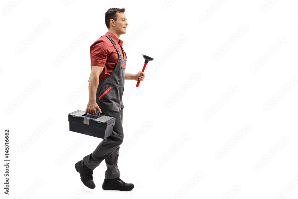 Plumber holding a plunger and a toolbox walking Plumber holding a plunger and a toolbox walking