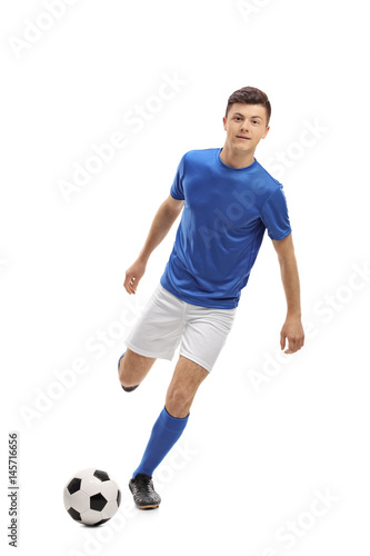 Teenage soccer player kicking a football © Ljupco Smokovski