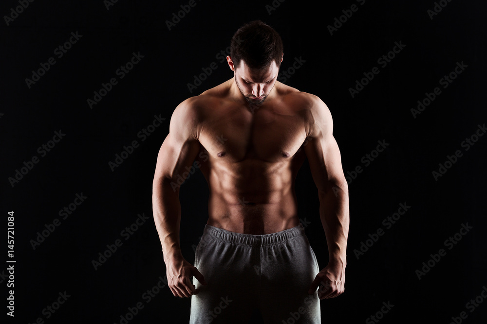Muscular and sexy torso of young man having perfect abs, bicep and chest. Male hunk with athletic body. Fitness concept Muscular and sexy torso of young man having perfect abs, bicep and chest. Male hunk with athletic body. Fitness concept