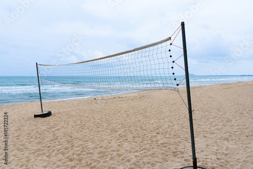 A beach volleyball net on the beach.