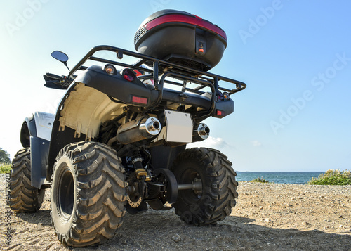 ATV offroad on sea and sky background