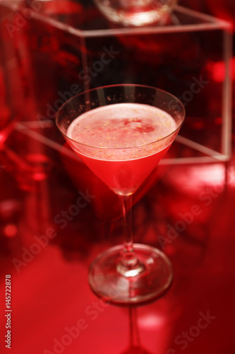 Red color cocktail drink on table
