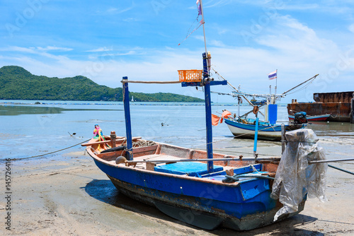 Fishing boats aground on the beach over cloudy sky at Prachuap Khiri Khan  Thailand.