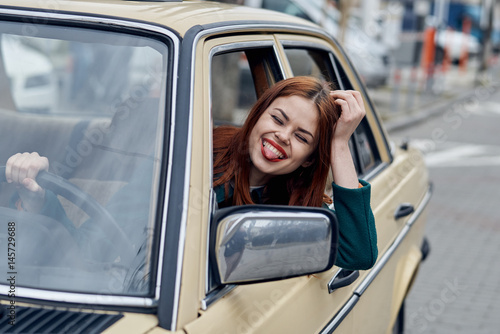 cheerful woman in the driver's seat, drive the car