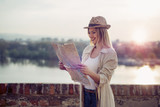 Happy blond female traveling and sightseeing