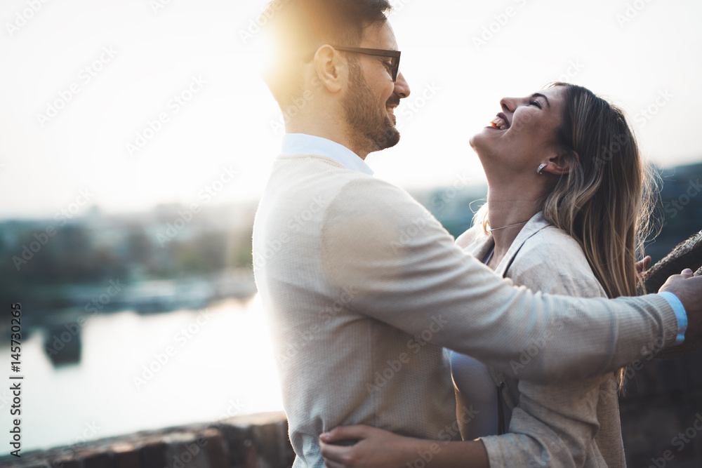Happy romantic couple hugging and smiling Stock Photo | Adobe Stock