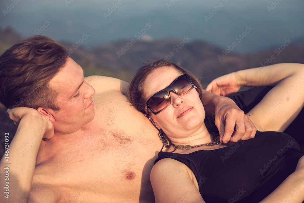 Loving couple on top of a mountain. Loving couple on top of a mountain.