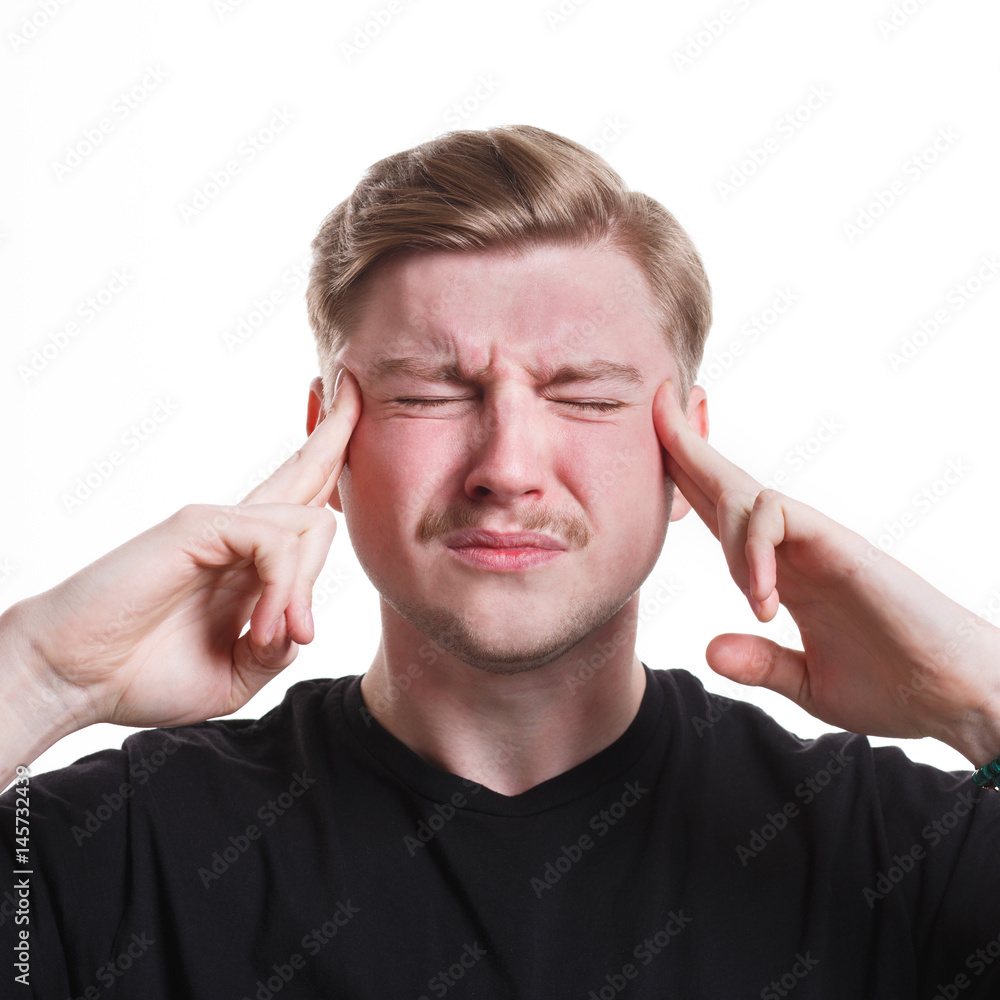 Concentrated pensive man holding fingers on temple Concentrated pensive man holding fingers on temple