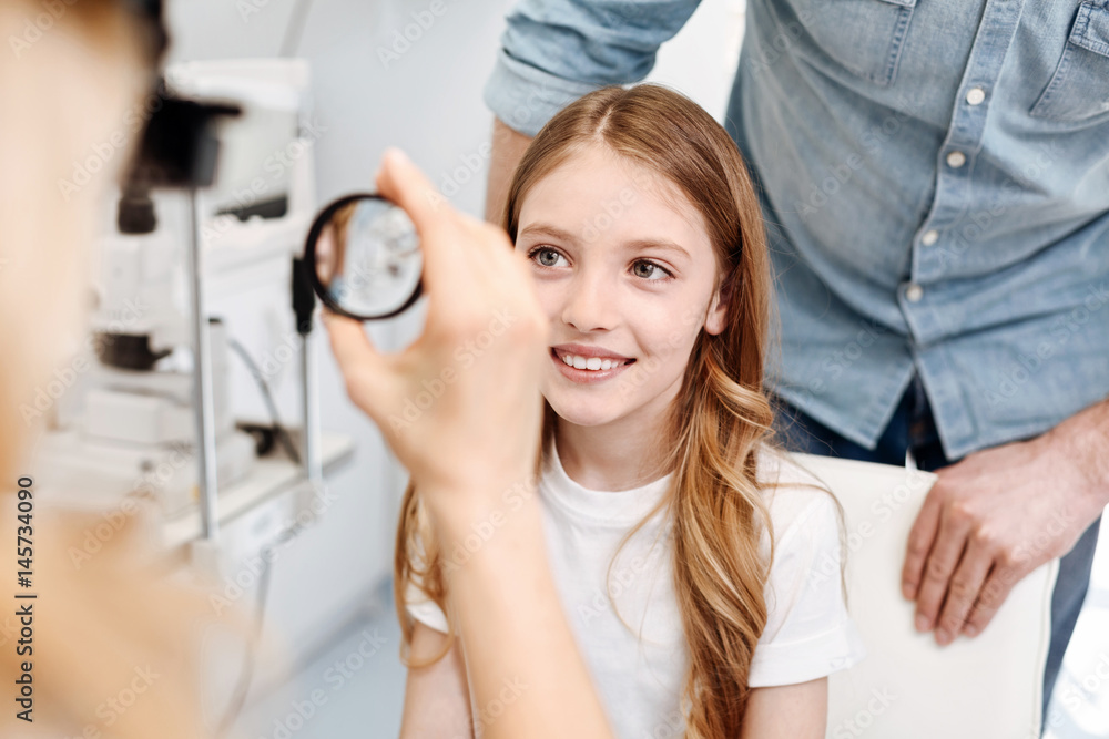 Focused clever child undergoing a checkup Focused clever child undergoing a checkup
