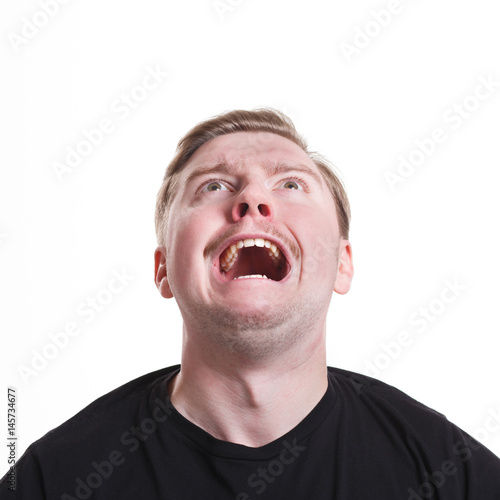 Facial negative expressions. Shouting man looking up, isolated on white background