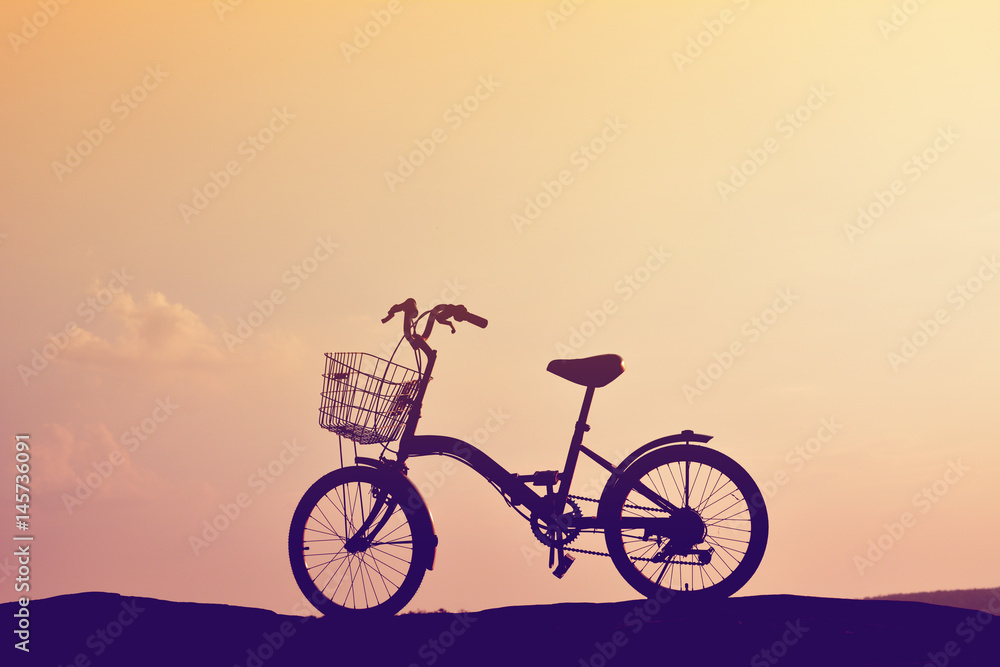 Silhouette of bicycle on nature with the sky sunset