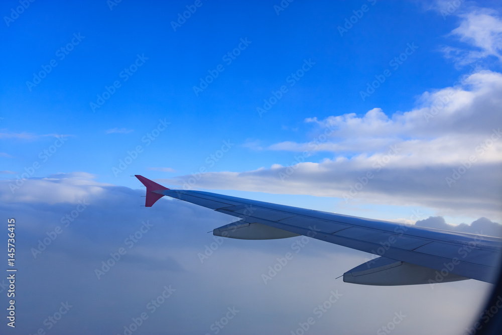 Fototapeta premium Beautiful view through Passenger plane window above the clouds