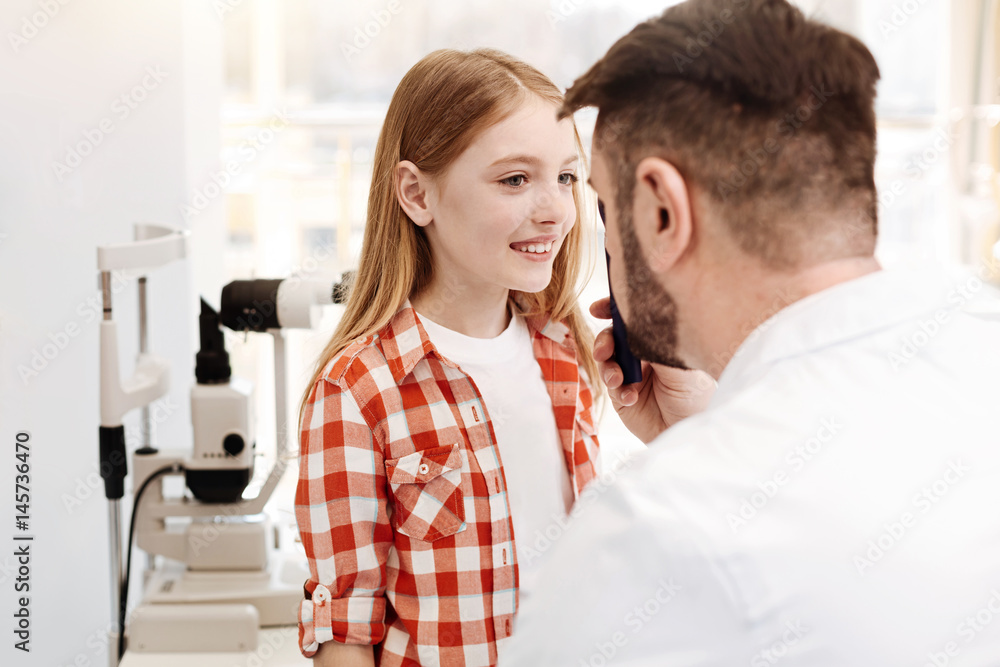 Competent cool doctor having a look at girls eyes Competent cool doctor having a look at girls eyes