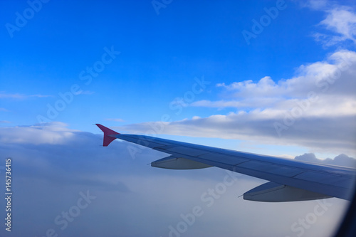 Beautiful view through Passenger plane window above the clouds