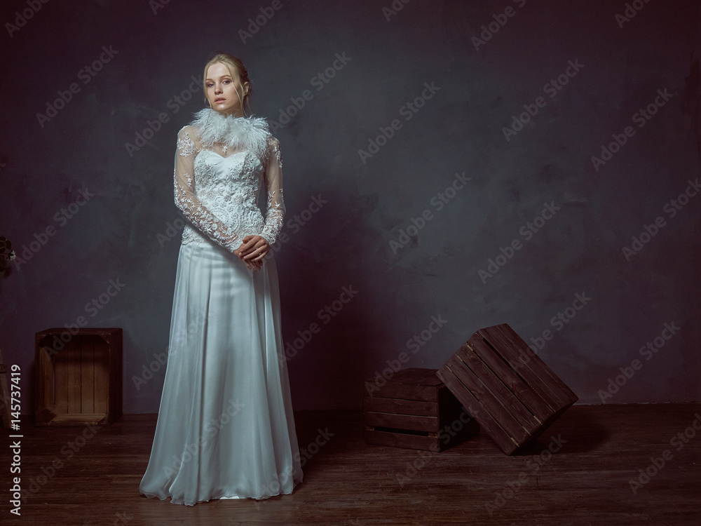 Tall blonde girl posing in elegant wedding dresses. Tall blonde girl posing in elegant wedding dresses.