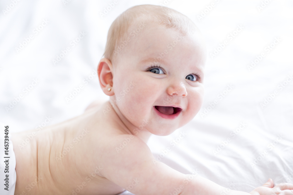 Baby girl in white bedding at home look nice Baby girl in white bedding at home look nice