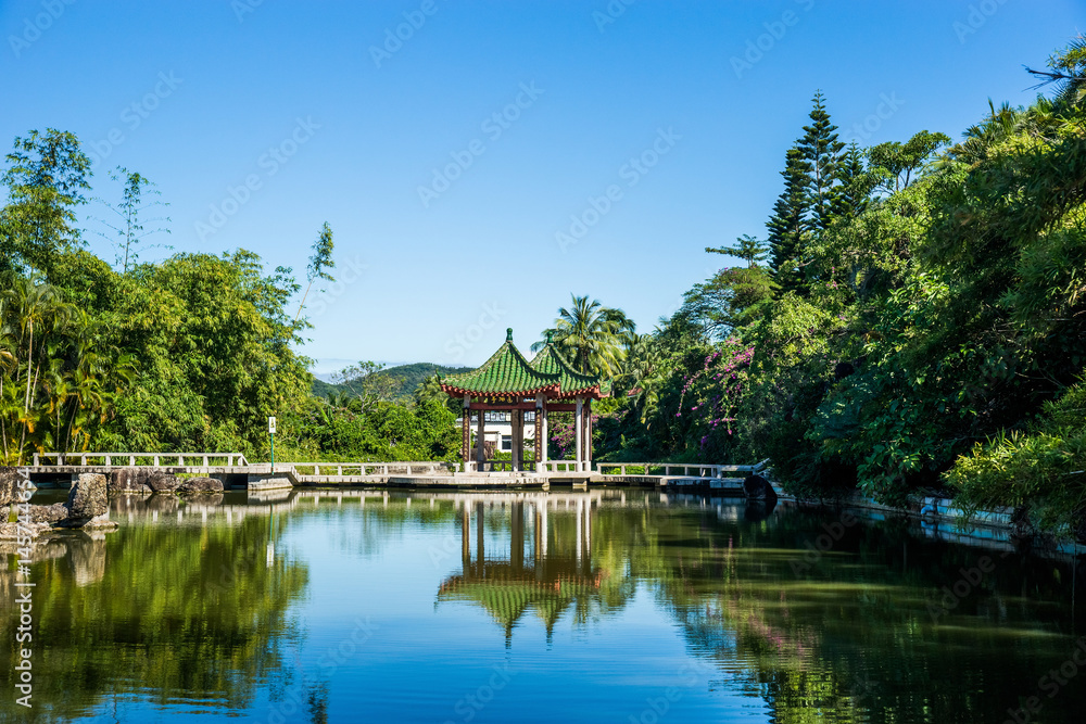 Beautiful chinese traditional garden with water pond in Nanshan temple. Hainan province, China.
