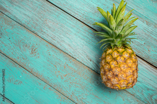 pineapple on the wood texture background..