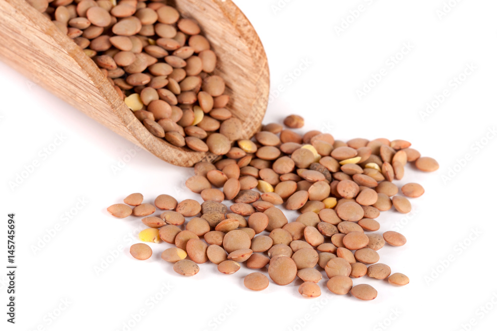 lentils in a wooden scoop isolated on white background lentils in a wooden scoop isolated on white background