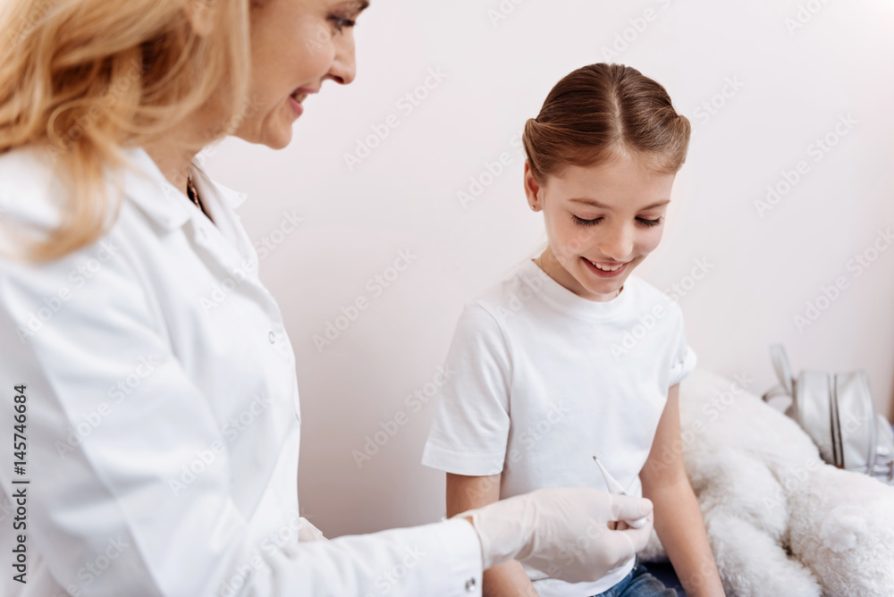 Profile photo of attractive nurse giving thermometer to her patient Profile photo of attractive nurse giving thermometer to her patient