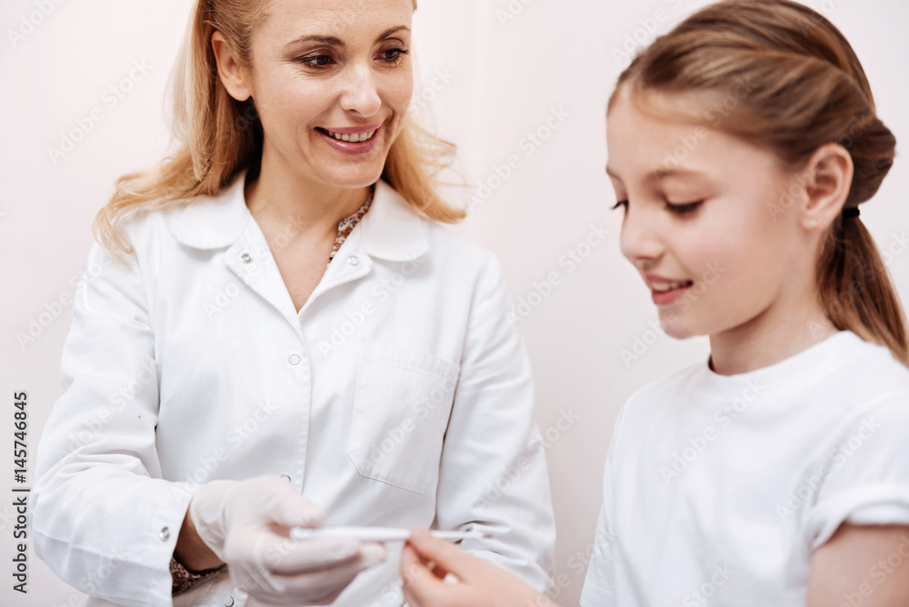 Positive delighted doctor looking at her patient Positive delighted doctor looking at her patient