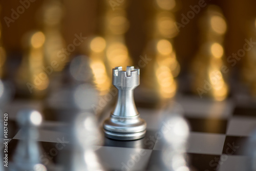 One chess pieces staying against full set of chess pieces