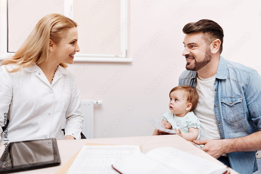 Positive delighted doctor looking at her patient