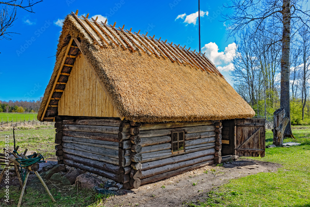 Old wooden sauna log cabin with thatched roof. Hiiumaa island, Estonia Old wooden sauna log cabin with thatched roof. Hiiumaa island, Estonia
