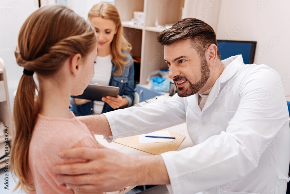 Attentive young pediatrician examining his patient Attentive young pediatrician examining his patient