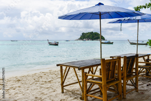 Chair with umbrella are on the beach