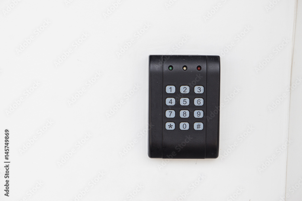 Door access control - young woman holding a key card to lock and unlock door., Keycard touch the security system to access the door Door access control - young woman holding a key card to lock and unlock door., Keycard touch the security system to access the door