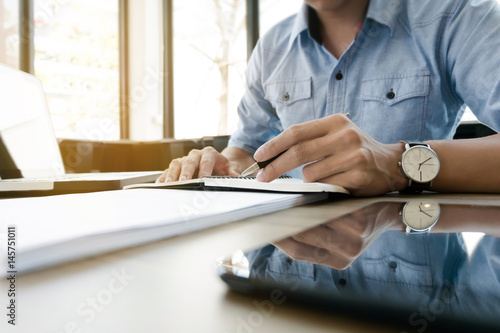 young business executive work in modern office on notebook and computer laptop..