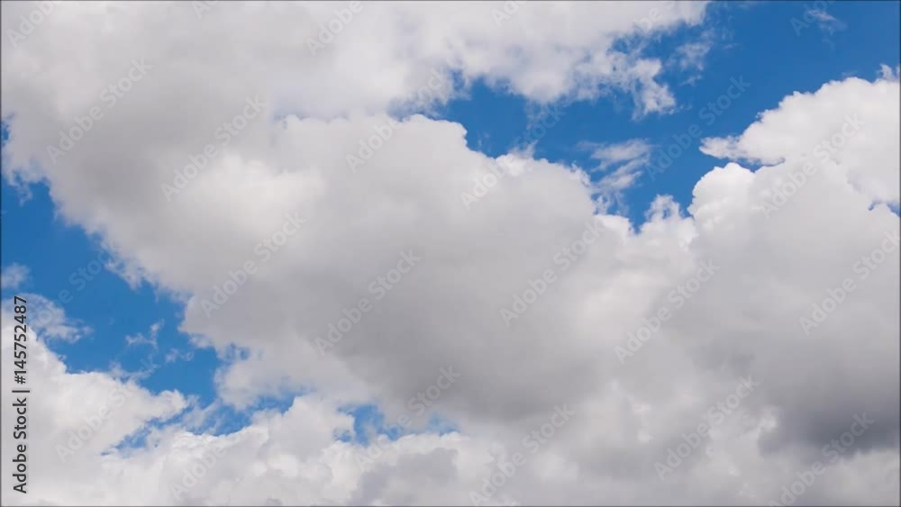 White clouds move across clear blue sky. Cloudy blue sky background.
