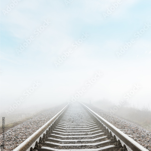 railroad closeup goes to horizon in fog