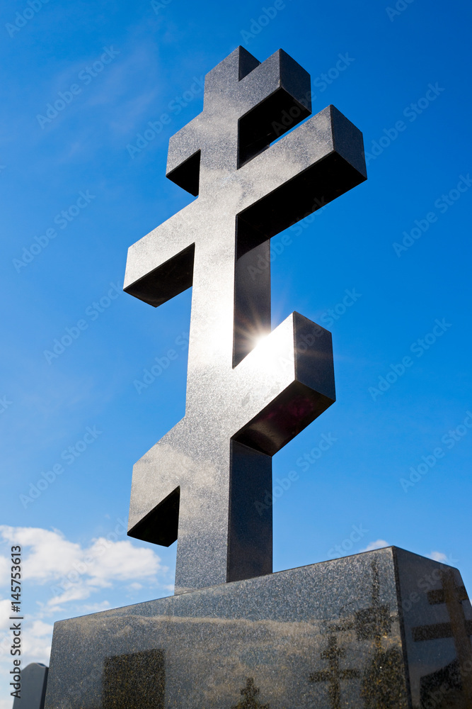 Black marble cross on the sky background Black marble cross on the sky background