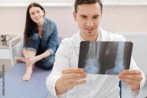 Delighted positive doctor having good news