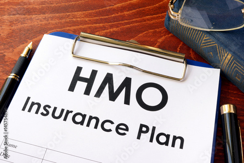 HMO Insurance Plan on a table. (Health Maintenance Organization) photo
