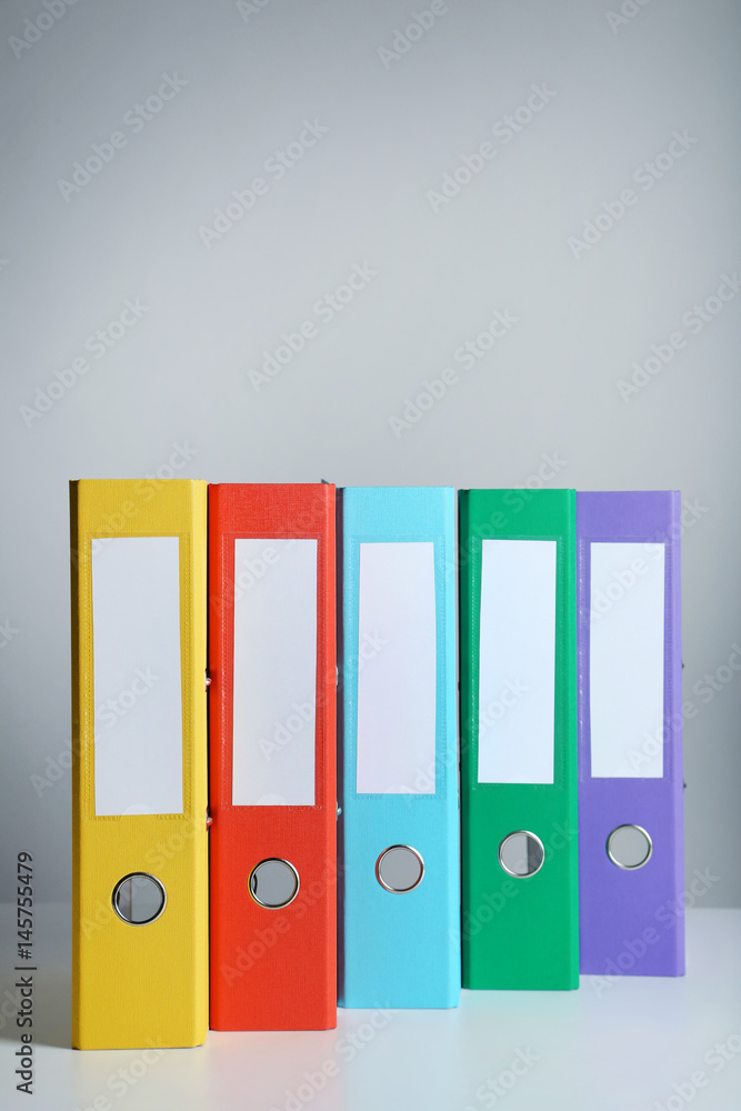 Colorful office folders on grey background Colorful office folders on grey background