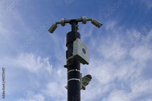 CCTV cameras in field , blue sky background.